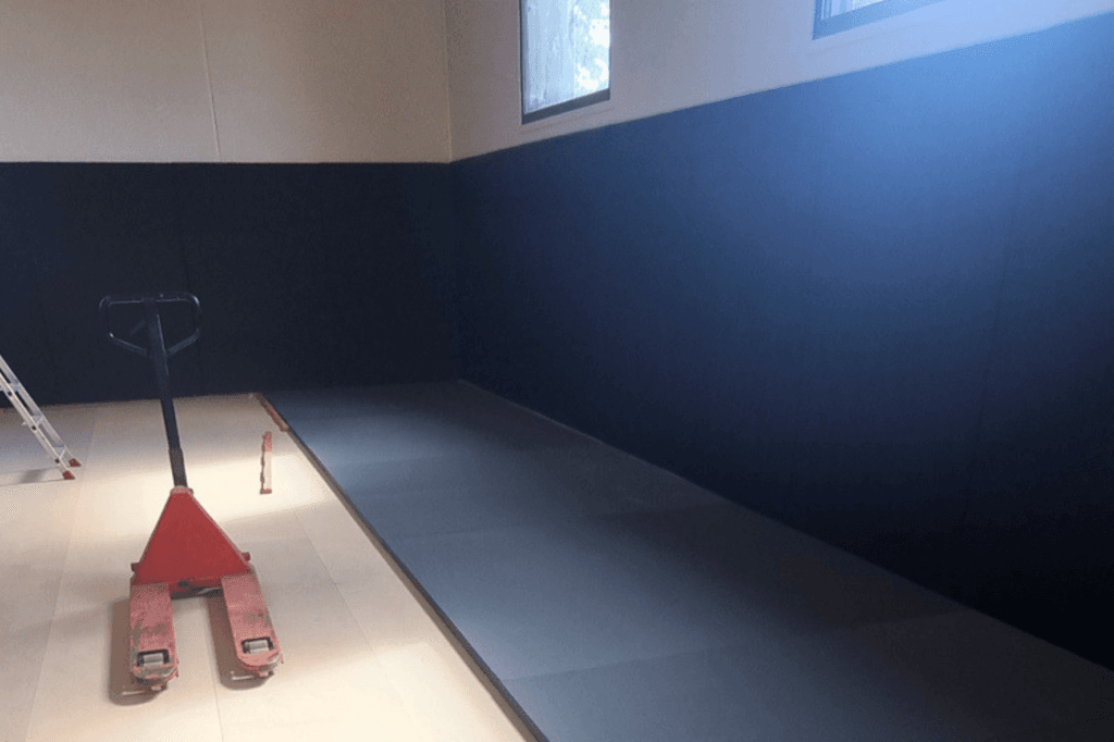 Protections murales capitonnées posées sur deux mètres de hauteur dans un dojo